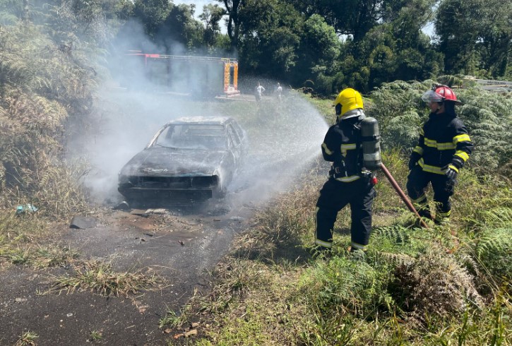 Bombeiros combatem incêndio em carro abandonado próximo ao trevão