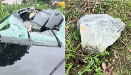 Pedra de 50 kg cai de caminhão, destrói teto de carro e deixa motorista gravemente ferida
