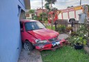 Carro sai da pista e colide em residência