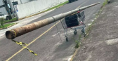 Homens carregam poste furtado em carrinho de supermercado
